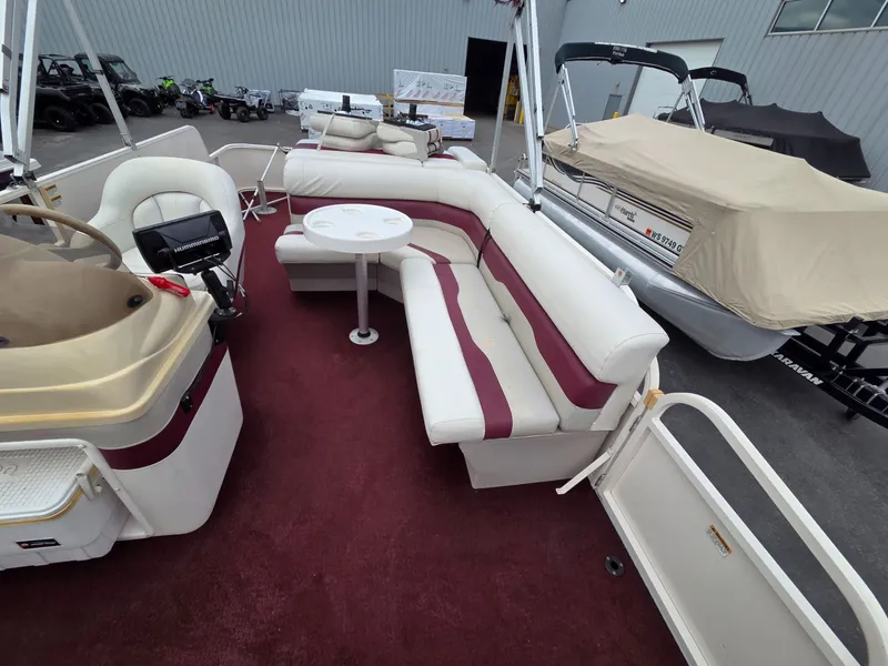 Slide: The Image of Interior of a 2005 Starcraft STR20 pontoon boat with red carpet. - 13