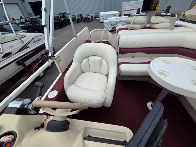 Slide: The Image of Interior of a 2005 Starcraft STR20 pontoon boat with white seating. - 17