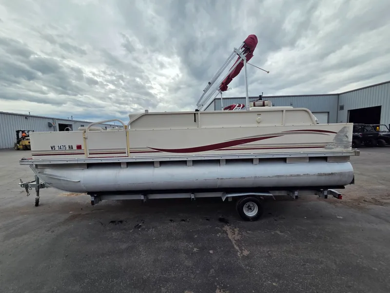 Slide: The Image of 2005 Starcraft STR20 pontoon boat on trailer, cloudy sky. - 2