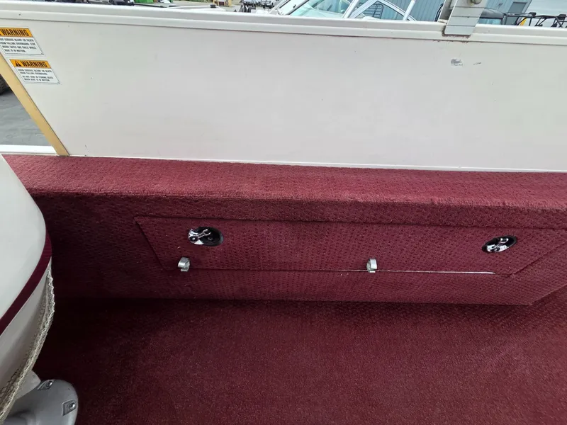 Slide: The Image of Interior of a 2005 Starcraft STR20 boat with red carpet. - 20