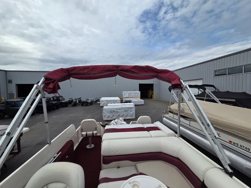 Slide: The Image of 2005 Starcraft STR20 boat with red canopy in storage area. - 27