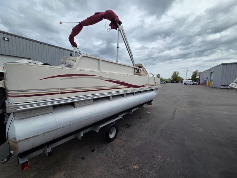 Slide: The Image of 2005 Starcraft STR20 pontoon boat on trailer, cloudy sky. - 5