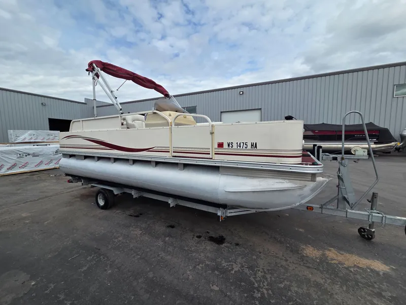 Slide: The Image of 2005 Starcraft STR20 pontoon boat with red canopy on trailer. - 6
