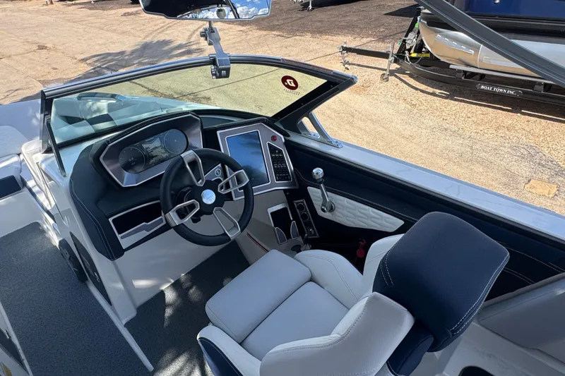 Slide: The Image of 2019 MasterCraft X24 boat interior with modern dashboard and steering wheel. - 10