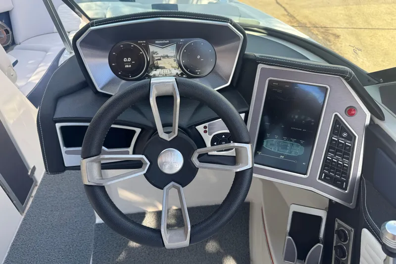 Slide: The Image of 2019 MasterCraft X24 dashboard with steering wheel and digital display controls. - 11