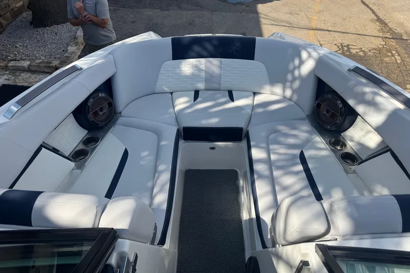 Slide: The Image of 2019 MasterCraft X24 boat interior with white seating and cup holders. - 13