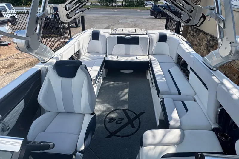 Slide: The Image of 2019 MasterCraft X24 boat interior with white seating and advanced wakeboard racks. - 15