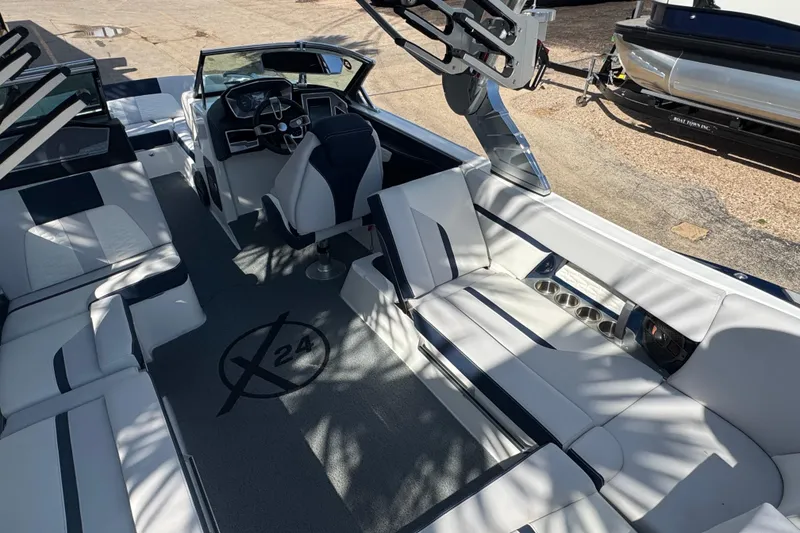 Slide: The Image of 2019 MasterCraft X24 boat interior with sleek seating and modern dashboard design. - 9