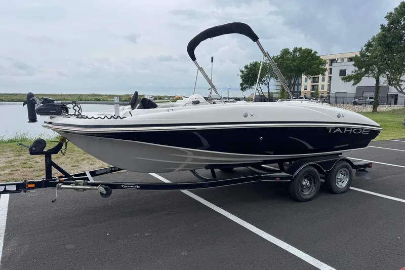 Slide: The Image of 2017 Tahoe 195 boat on trailer in parking lot near water. - 10