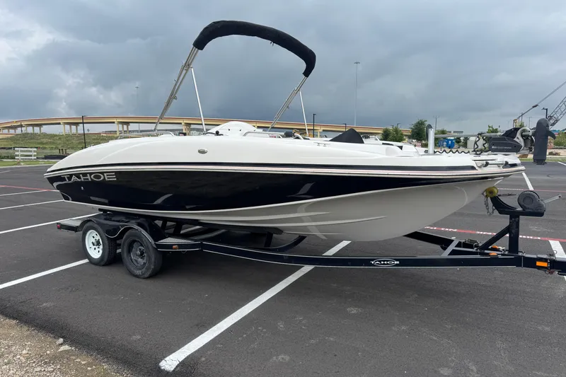 Slide: The Image of 2017 Tahoe 195 boat on trailer in parking lot, overcast sky. - 12
