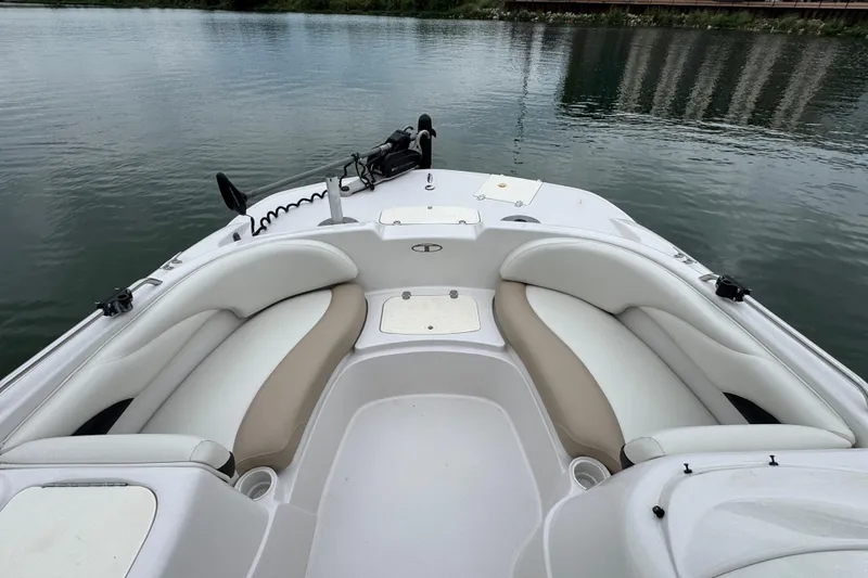 Slide: The Image of 2017 Tahoe 195 boat interior with white seating on calm water. - 13