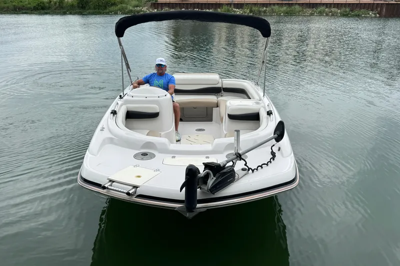Slide: The Image of Man on a 2017 Tahoe 195 boat in calm waters. - 5