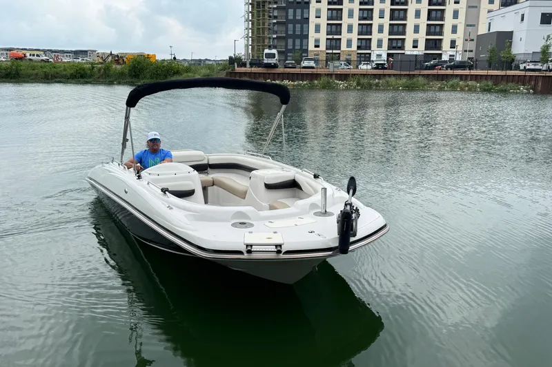 Slide: The Image of 2017 Tahoe 195 boat on water near urban buildings. - 6