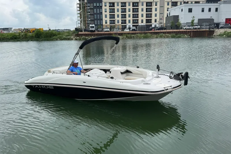 Slide: The Image of 2017 Tahoe 195 boat on water near urban buildings. - 7