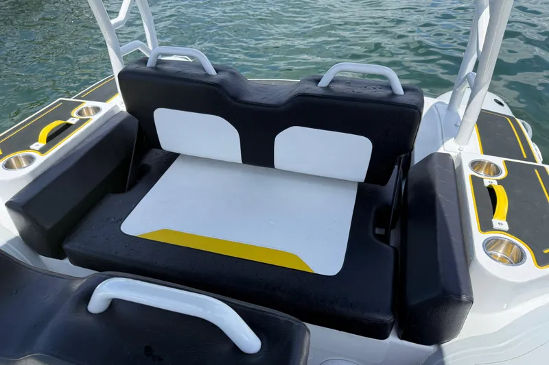 Slide: The Image of Highfield Velox 560 boat seating area with black and white cushions, 2026 model. - 11