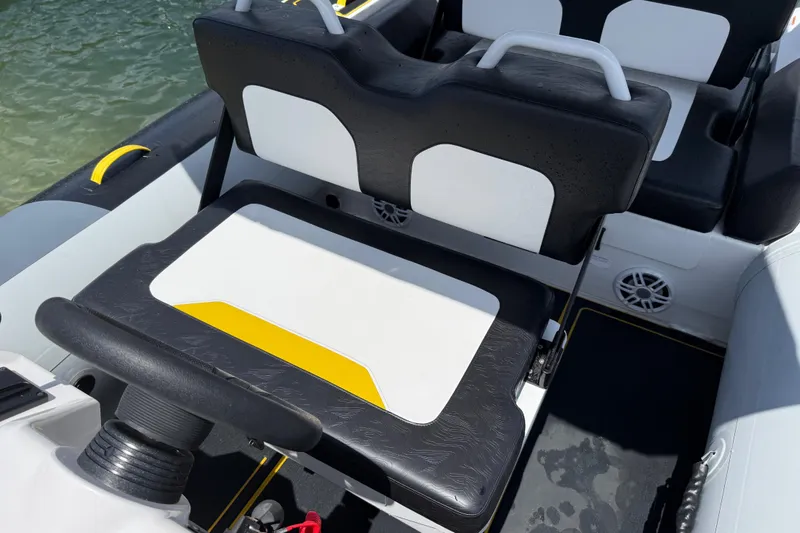 Slide: The Image of 2026 Highfield Velox 560 boat interior with black and white seating, yellow accents. - 12