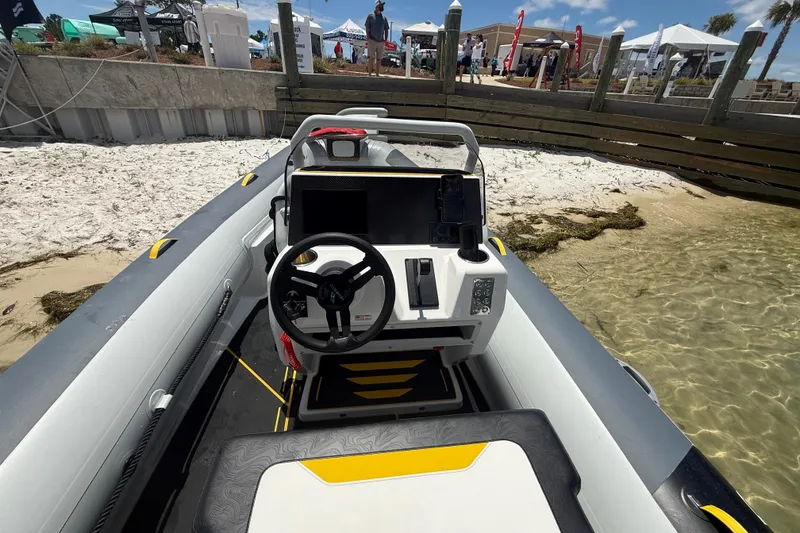 Slide: The Image of Highfield Velox 560 boat interior, 2026 model, docked on sandy beach with clear water. - 9