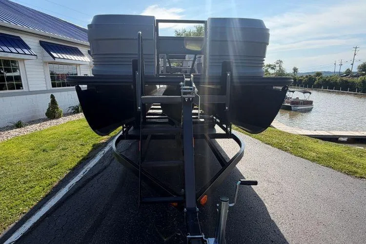 Slide: The Image of 2026 SunChaser Lucerne 22 LR DH Sport pontoon boat on trailer, parked near water. - 4