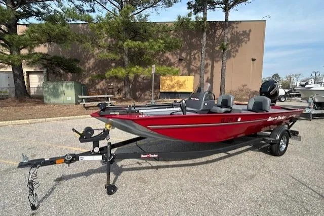 The Image of 2025 Tracker Bass Tracker Classic XL boat in a parking lot, red exterior, on a trailer. - 0