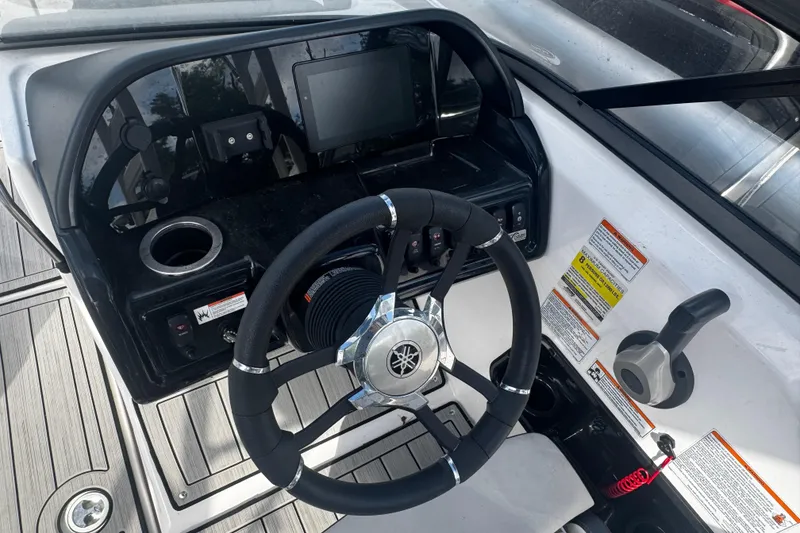Slide: The Image of Steering console of 2021 Yamaha Boats 195S with controls and display. - 2