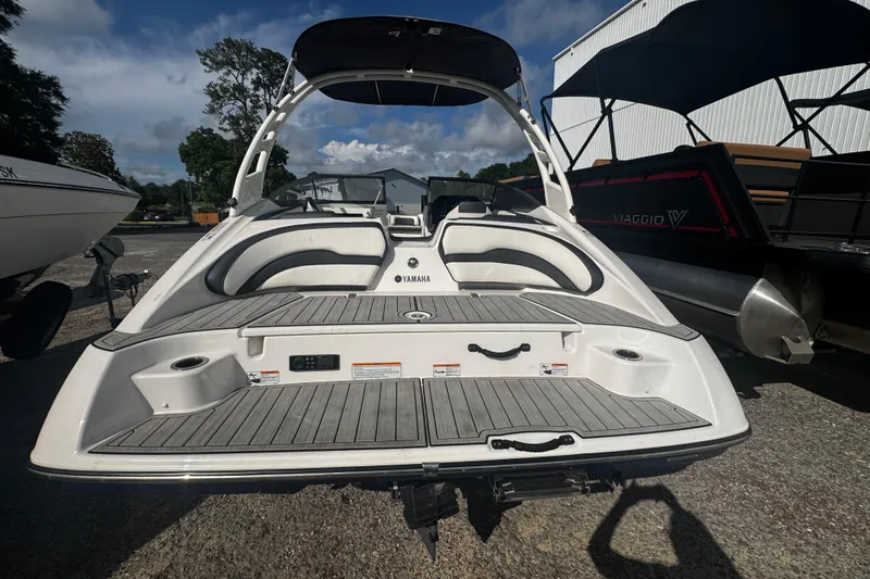Slide: The Image of 2021 Yamaha Boats 195S, rear view, showcasing spacious deck and seating area. - 6