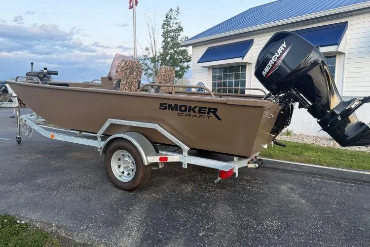 The Image of 2026 Smoker Craft Sportsman 1660 boat on trailer with Mercury outboard motor. - 0