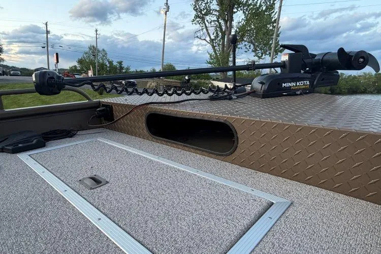 Slide: The Image of 2026 Smoker Craft Sportsman 1660 boat with Minn Kota trolling motor on deck. - 7