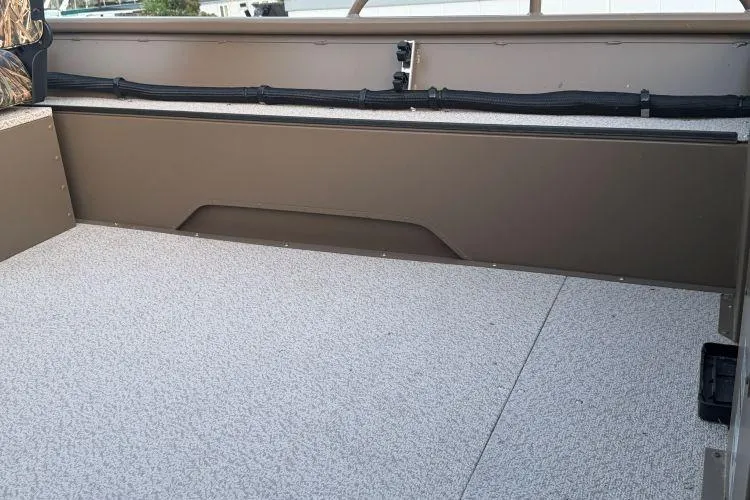 Slide: The Image of 2026 Smoker Craft Sportsman 1660 boat interior with spacious, textured flooring and sleek design. - 8