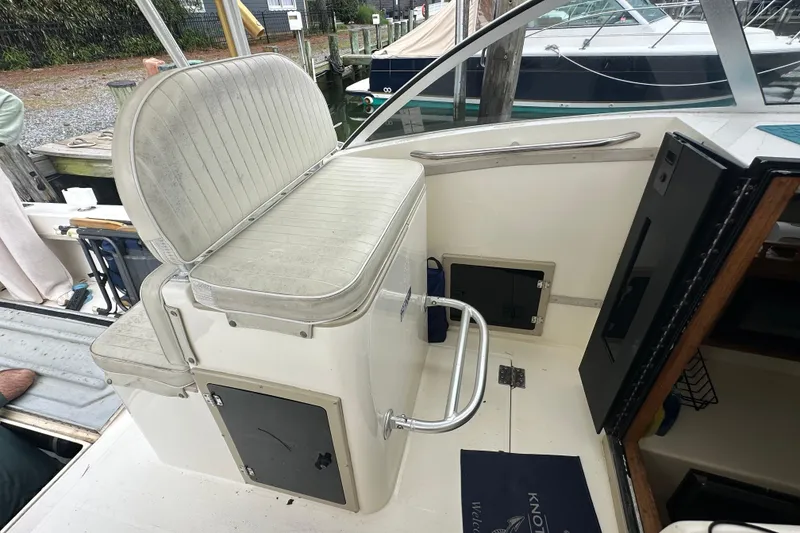 Slide: The Image of 2000 Albemarle 280 Express Fisherman boat interior with seating and storage compartments. - 14