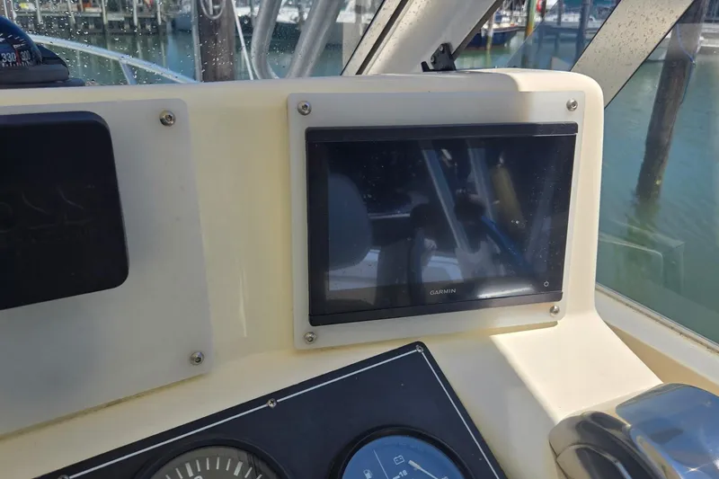 Slide: The Image of Dashboard of a 2000 Albemarle 280 Express Fisherman with Garmin display and gauges. - 4