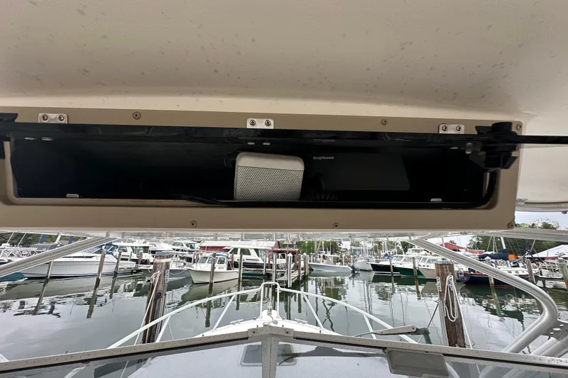 Slide: The Image of 2000 Albemarle 280 Express Fisherman boat with open storage compartment, docked at marina. - 29