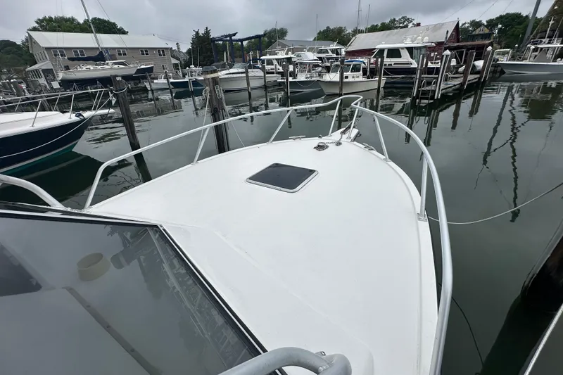 Slide: The Image of 2000 Albemarle 280 Express Fisherman docked at a marina, surrounded by other boats. - 23