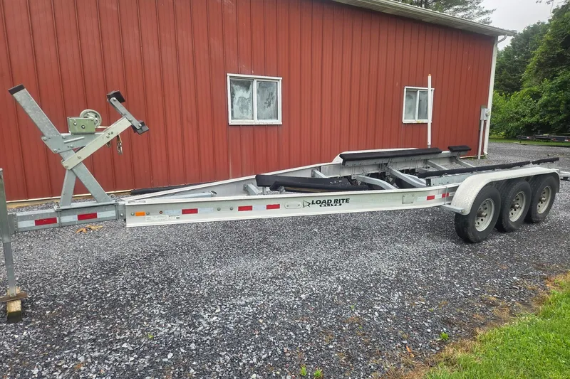 Slide: The Image of Trailer for 2000 Albemarle 280 Express Fisherman beside red building. - 7