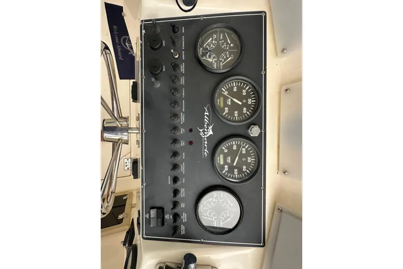Slide: The Image of Control panel of a 2000 Albemarle 280 Express Fisherman boat with gauges and switches. - 16