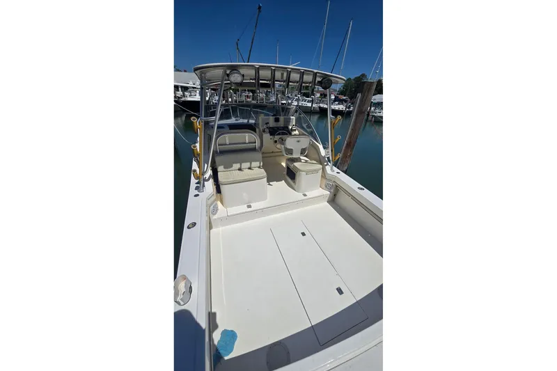 Slide: The Image of 2000 Albemarle 280 Express Fisherman boat docked at marina, spacious deck view. - 2