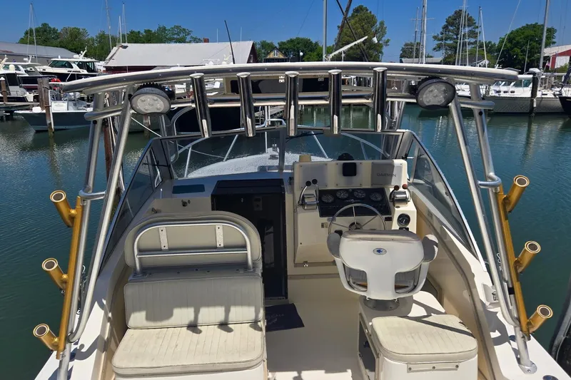 Slide: The Image of 2000 Albemarle 280 Express Fisherman boat interior with helm and seating at marina. - 3
