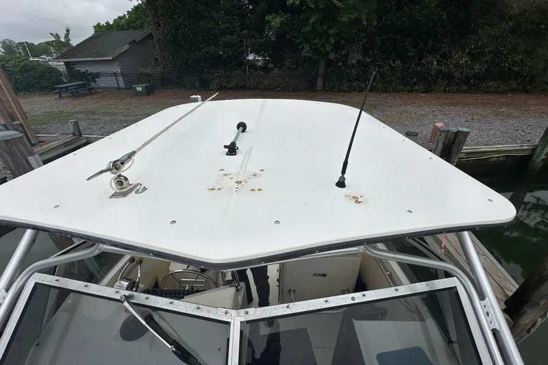 Slide: The Image of Top view of a 2000 Albemarle 280 Express Fisherman boat docked near a wooded area. - 24
