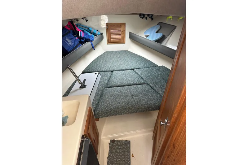 Slide: The Image of Interior cabin of 2000 Albemarle 280 Express Fisherman with cushioned seating and storage. - 19