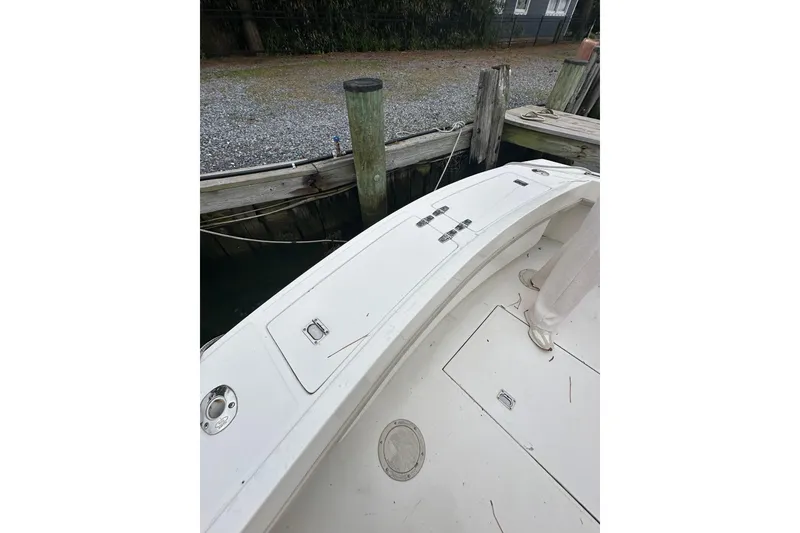 Slide: The Image of 2000 Albemarle 280 Express Fisherman boat docked, showing deck and storage compartments. - 28