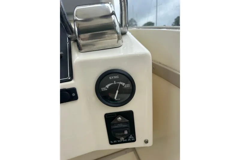 Slide: The Image of Control panel of a 2000 Albemarle 280 Express Fisherman boat, featuring a sync gauge. - 18