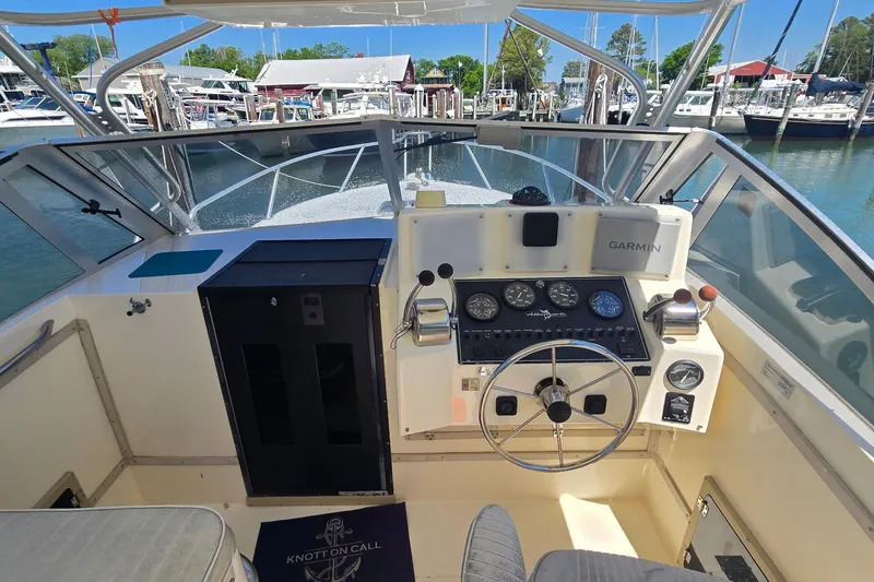 Slide: The Image of Cockpit view of 2000 Albemarle 280 Express Fisherman boat with steering wheel and navigation instruments. - 6