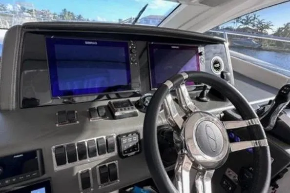 Slide: The Image of Steering wheel and dashboard of 2023 Schaefer 400 yacht with navigation screens. - 1