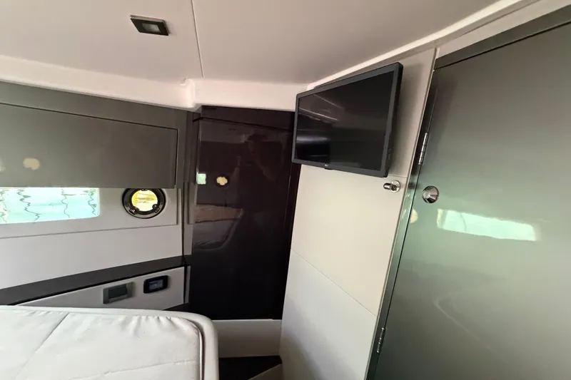 Slide: The Image of Interior of 2023 Schaefer 400 yacht cabin with TV and porthole window. - 12