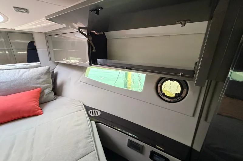 Slide: The Image of Interior of 2023 Schaefer 400 yacht with modern cabinetry and cozy bedding. - 15