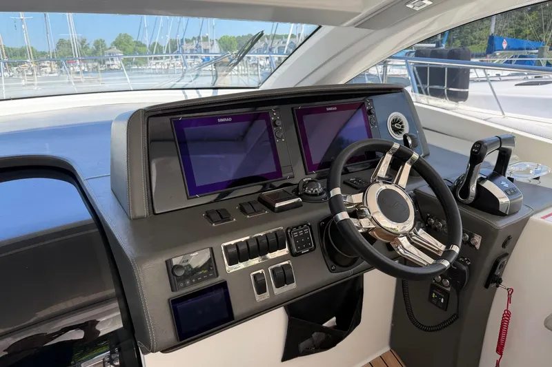 Slide: The Image of Helm of 2023 Schaefer 400 yacht with modern navigation equipment and steering wheel. - 16