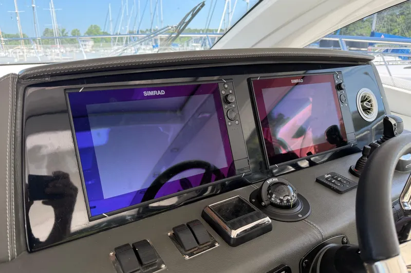 Slide: The Image of Dashboard of 2023 Schaefer 400 yacht with dual Simrad displays and navigation controls. - 17
