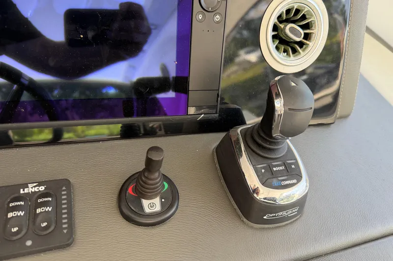 Slide: The Image of Control panel of a 2023 Schaefer 400 boat with joystick and touchscreen display. - 19