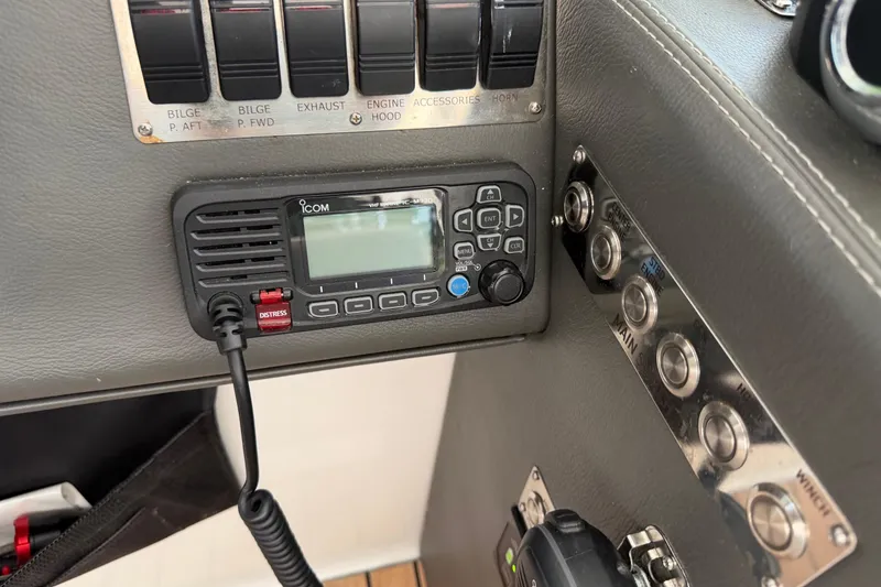 Slide: The Image of Control panel of a 2023 Schaefer 400 boat with Icom radio and switches. - 20