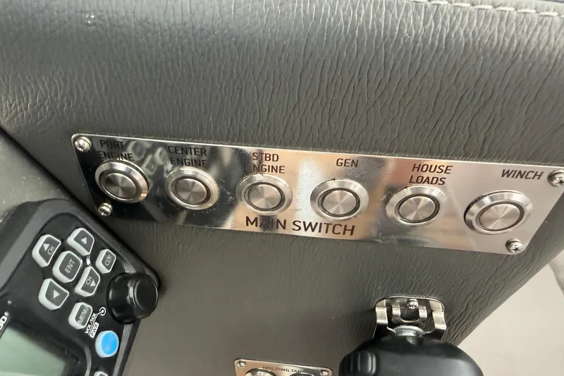 Slide: The Image of Control panel with labeled switches for engines, generator, and winch on a 2023 Schaefer 400. - 21
