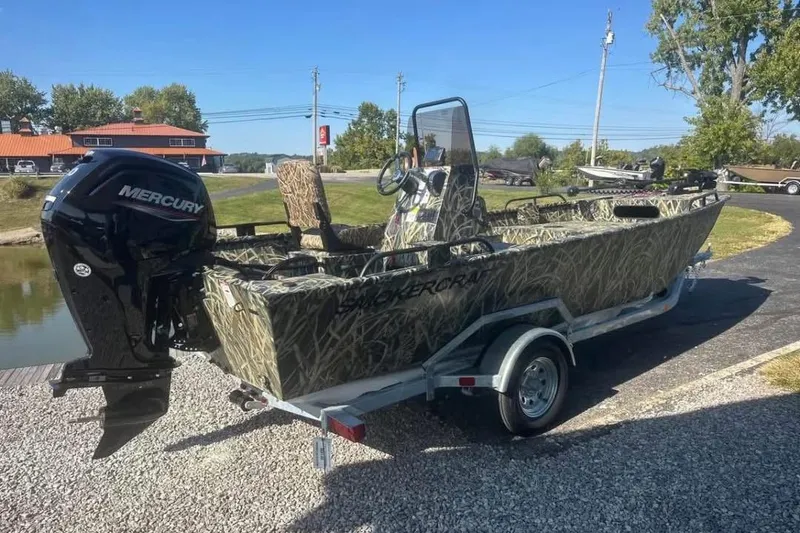 The Image of 2026 Smoker Craft Sportsman 1866 boat with camouflage design and Mercury outboard motor. - 0